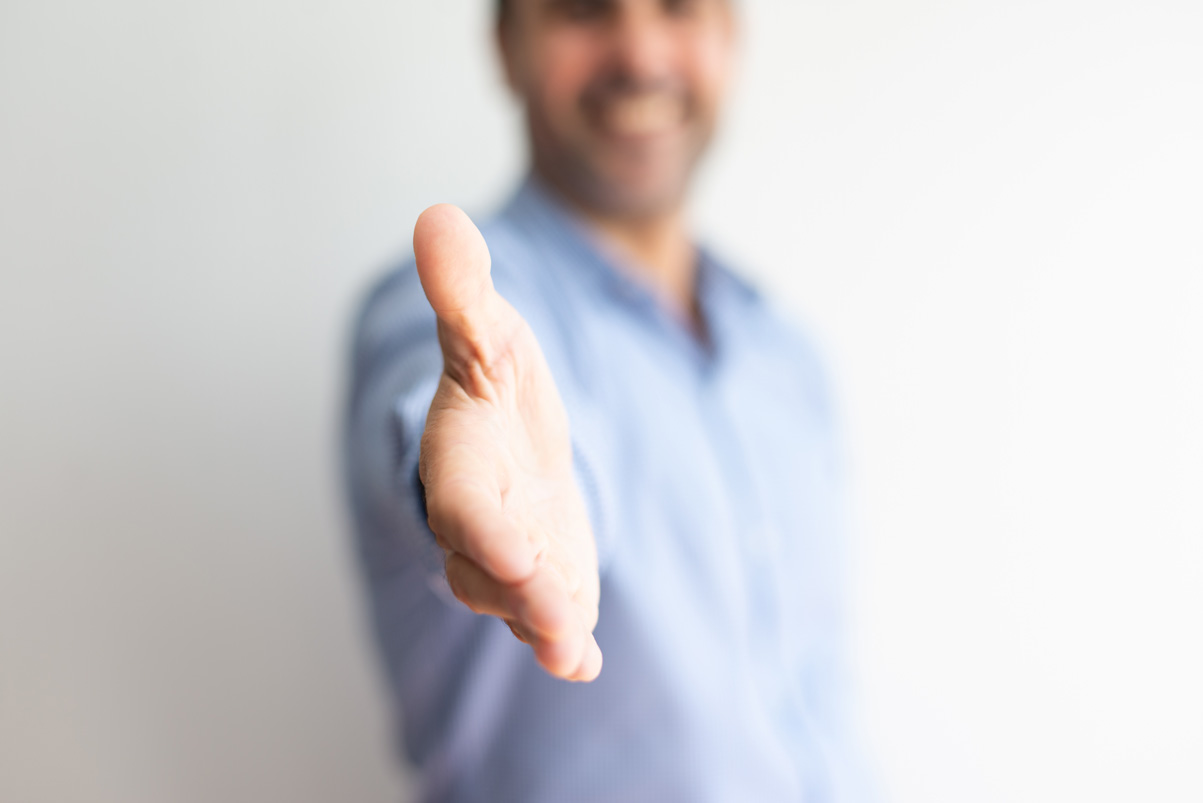 closeup-business-man-offering-hand-handshake